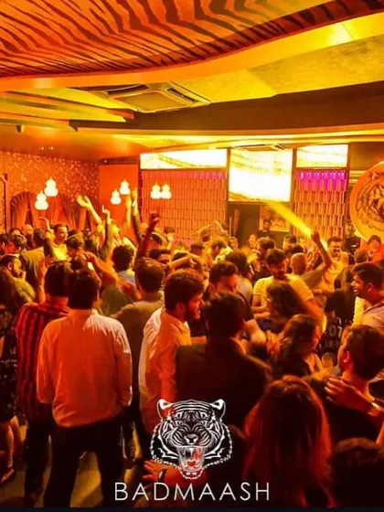 A snapshot of a typical high-energy Bollywood night at Badmaash. The dance floor is completely packed, with everyone's hands in the air, lost in the music.