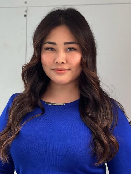 A portrait of my client with her new warm brown brunette hair. The color enhances her natural beauty and gives her a radiant glow.