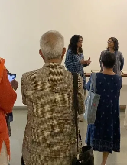 The audience listening as the curator explains the concepts behind the exhibition.