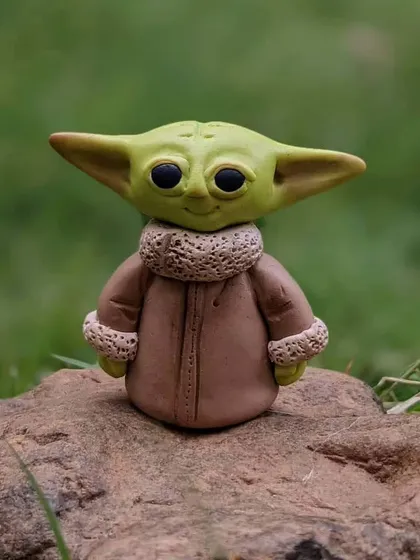 A Jedi Master in miniature form. This Baby Yoda sculpture is a perfect gift for any Star Wars fan.