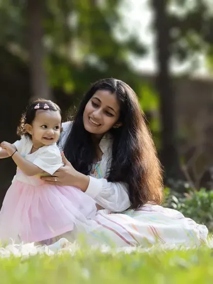 A tender moment between a mother and her baby girl, enjoying a sunny day in the park. Outdoor lifestyle sessions allow for natural and relaxed interactions.