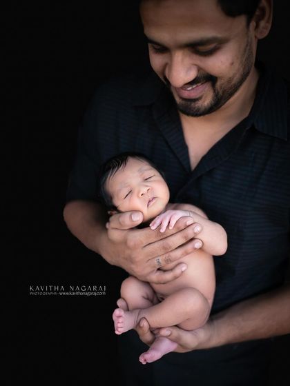 A different angle of a father holding his nine-day-old newborn. The black and white treatment adds a timeless, classic feel to this loving portrait.