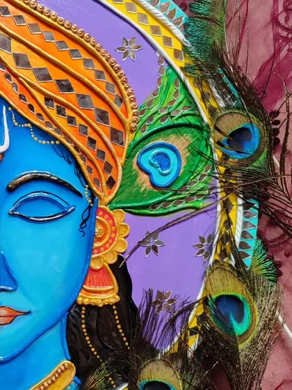 A close up of my Krishna Lippan art, showing the detailed 3D clay and mirror work. This piece combines the traditional art form of Kutch with a divine depiction of Lord Krishna, complete with his peacock feather.