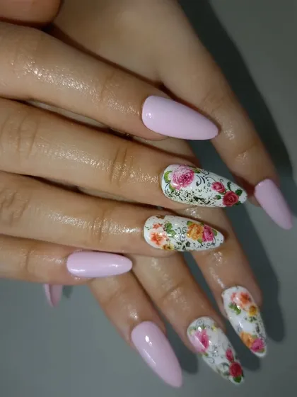 A beautiful floral design on a white base, paired with soft pink nails for a romantic and classic bridal or everyday look.