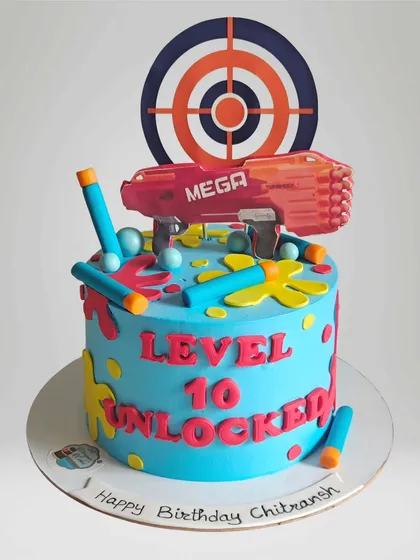 A Nerf gun-themed cake that says "Level 10 Unlocked". This is a perfect design for an older kid's birthday party, with bright colors and a fun gaming vibe.