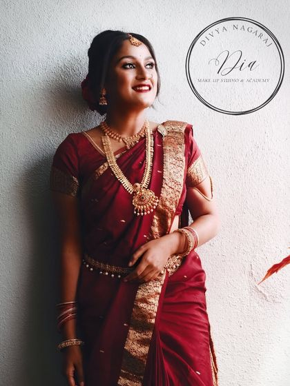 A full-length shot capturing the grace of this traditional look. The makeup, saree, and pose all work together to create a feeling of timeless beauty.