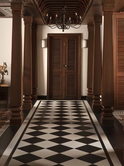 A long hallway in the House of Gond featuring our classic checkerboard tiles. The pattern creates a strong sense of direction and grandeur, merging heritage craftsmanship with modern design.
