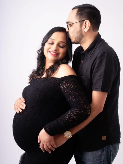 A quiet moment of connection. A gentle kiss on the forehead speaks volumes. I love capturing these unscripted, tender interactions that show the deep love between partners during a maternity shoot.