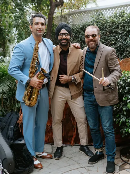 Me with my talented collaborators, a saxophonist and a percussionist. We work together as a team to create a cohesive and electrifying live performance.