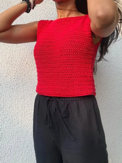 Our simple yet bold summer top in a striking red. The sleeveless, high-neck design is modern and can be easily dressed up or down.