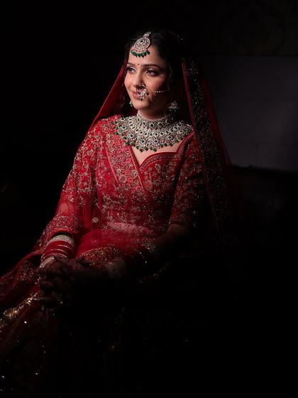 Urvashi's subtle and natural bridal look. We focused on soft, shimmery eyes and flawless skin to complement her gorgeous red lehenga and emerald jewellery.