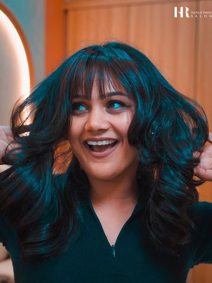 A fun and fresh haircut with bangs and soft layers. This style adds a youthful and playful vibe.