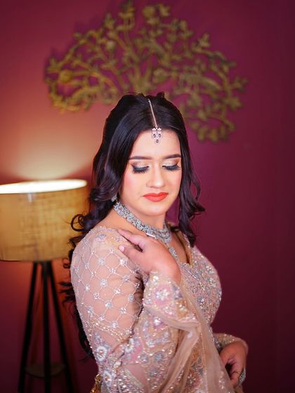 A beautiful profile shot that showcases the hairstyle and the intricate embroidery on the blouse.