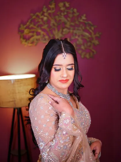 A beautiful profile shot that showcases the hairstyle and the intricate embroidery on the blouse.