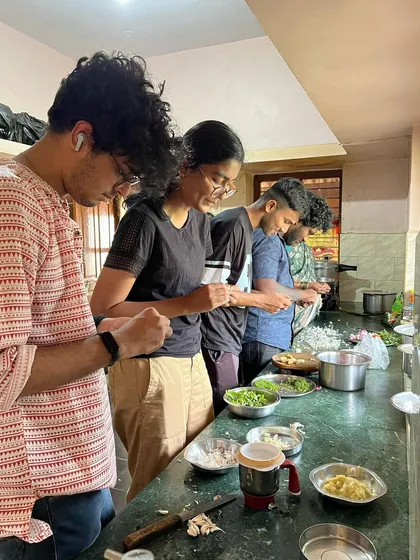 A moment of shared work and learning during a workshop. The kitchen area often becomes a space for communal activities, from prepping materials to sharing a meal.