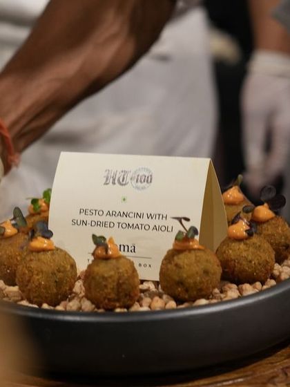 Pesto Arancini with Sun-dried Tomato Aioli, a popular choice for cocktail events. Each bite is packed with flavor, showcasing our expertise in creating gourmet Italian appetizers.