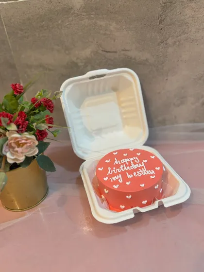A simple and sweet bento cake for a best friend's birthday. The coral-colored cake is decorated with tiny white hearts and a "happy birthday my besty" message.