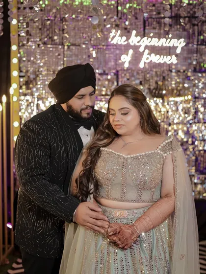 A beautiful couple shot. The bride's soft, open hairstyle is romantic and modern, perfect for this "beginning of forever" moment.