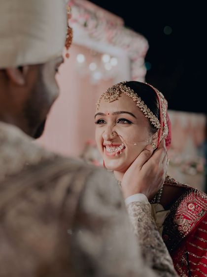 A sweet, intimate moment between the bride and groom. Her makeup looks flawless even in this close-up, emotional shot.