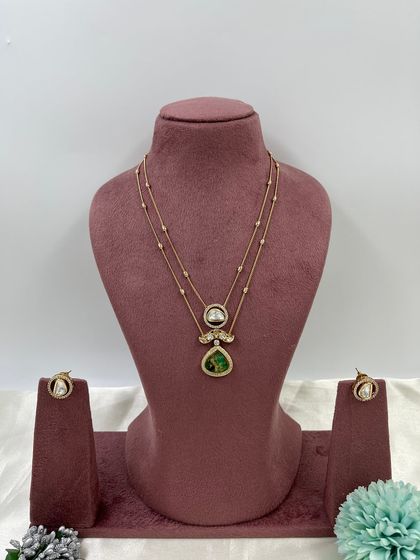 The Myra Crystal Bloom Necklace. This is another lightweight, double-chain design with crystal pendants, perfect for modern and minimalist tastes. Available in red and green.