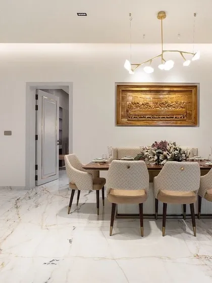 A full view of the dining room, where our custom table, chairs, and bench are centered under a beautiful hand-carved mural of The Last Supper.