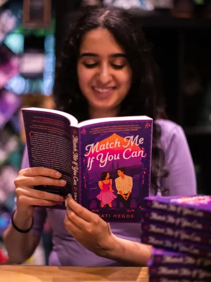 Reading my debut novel, *Match Me If You Can*, in a cafe. It's a dream come true to see my book in the world.