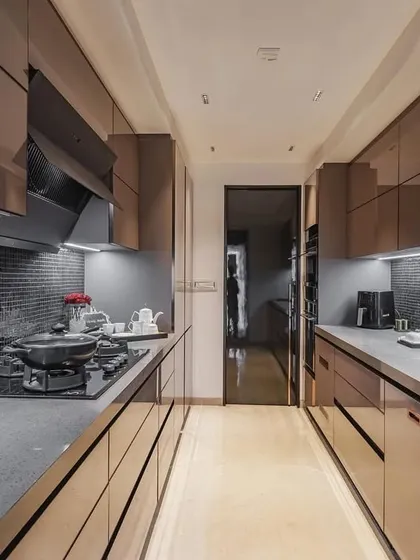 A full view of the parallel acrylic kitchen, showcasing its sleek, reflective surfaces.