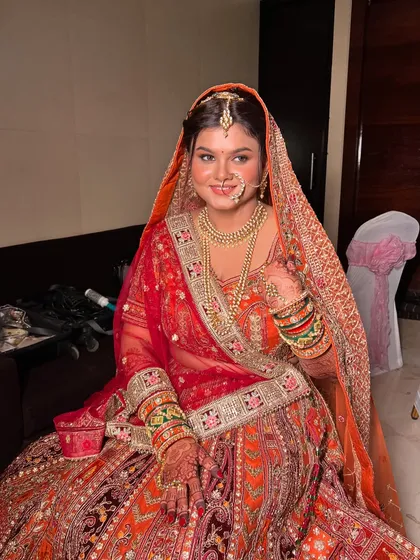 A beautiful portrait of the bride, her makeup and jewellery perfectly complementing her ornate lehenga.