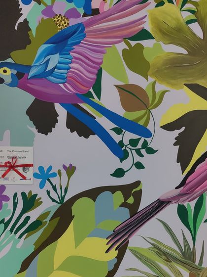 A detail of the colorful parrots in 'The Promised Land' mural.