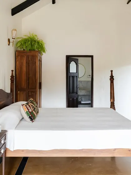 In Maison Rouge, we blended old and new by pairing a refurbished antique four-poster bed with a modern, minimalist aesthetic. This approach honors the family's history while creating a contemporary vacation home in the Konkan countryside.