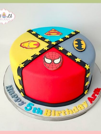 A superhero mashup cake for a 5th birthday. This design is divided into four sections, representing Superman, Batman, Iron Man, and Spider-Man.