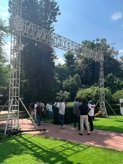 The entrance to an outdoor brand event, marked by a large truss structure. We build custom staging and rigging to define the event space and support lighting and sound equipment.