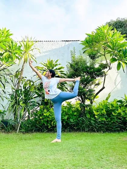 Yoga does not start or end on your mat. Practicing Dancer's Pose in a garden, surrounded by greenery, is a beautiful way to connect with the earth.