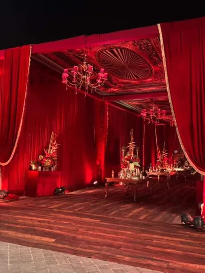 For a classic, royal wedding theme, you can't go wrong with rich red velvet. This is the entrance to a grand banquet hall I designed, using heavy drapes, ornate chandeliers, and warm lighting to create a dramatic and opulent passageway for guests.