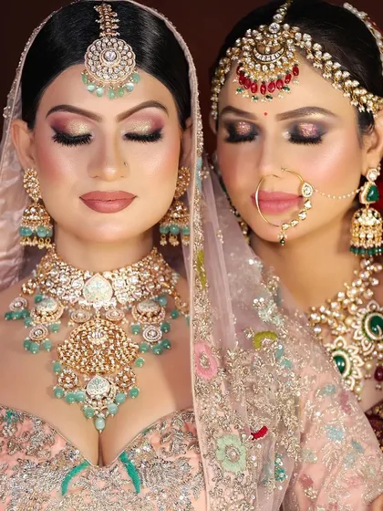 A moment of serene beauty. This image highlights the flawless eye makeup on both brides, from a neutral shimmer to a more dramatic smokey look.