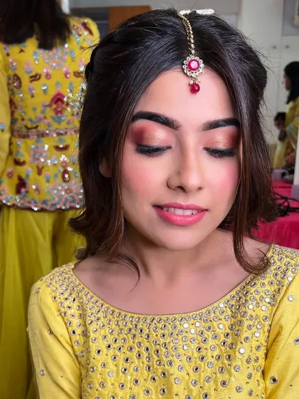 Another angle showing the beautiful blend of colors on her eyelids, perfect for her festive yellow mirror-work outfit.