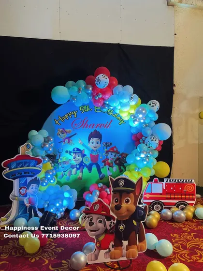 The Paw Patrol theme setup illuminated with LED lights inside the balloons, creating a vibrant glow for an evening party.
