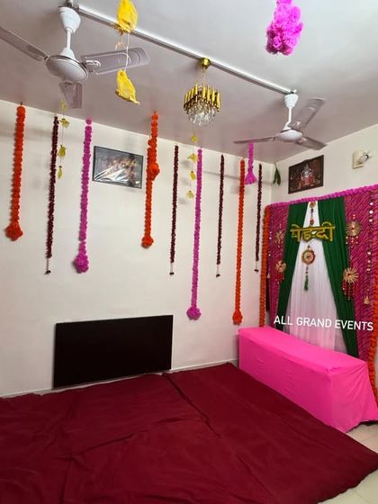 This photo shows how our Mehendi backdrop fits perfectly into a Mumbai apartment. We also added colorful flower strings hanging from the ceiling to make the entire room feel festive.