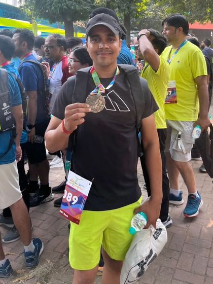 Holding my finisher's medal after a tough race. This is the feeling of accomplishment I help my clients achieve.