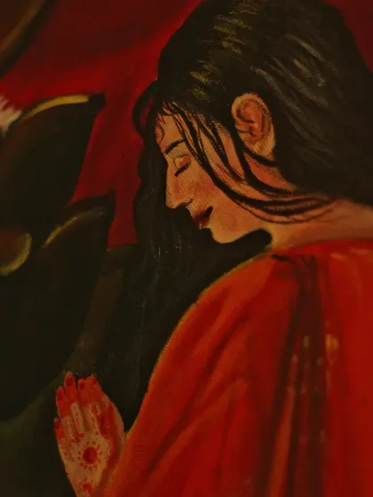 A close-up on the serene expression of the devotee in the Ganesha painting, capturing a moment of pure devotion.