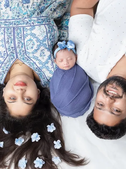 A creative overhead shot that makes for a unique and artistic family portrait with a newborn.