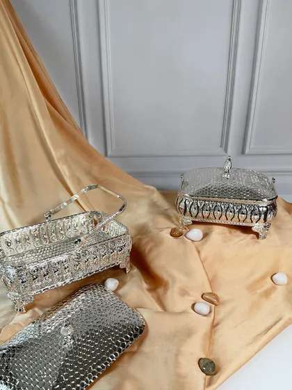 The lids are removed to show the utility of these beautiful silver baskets. They are as practical for storage as they are elegant for display.