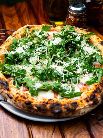 Our Grana e Rucola pizza, with fresh arugula and shaved parmesan. A refreshing classic.