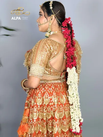A view of the intricate floral braid hairstyle from the back, a key element of the traditional bridal look.