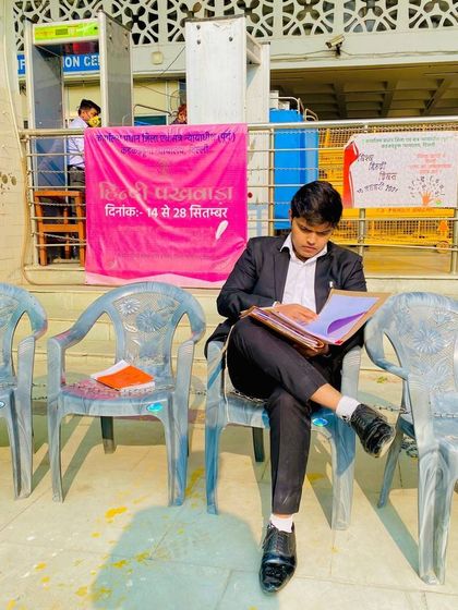 Studying a case file while waiting at the court. Some call lawyers legal thieves; I call us strategic fighters.