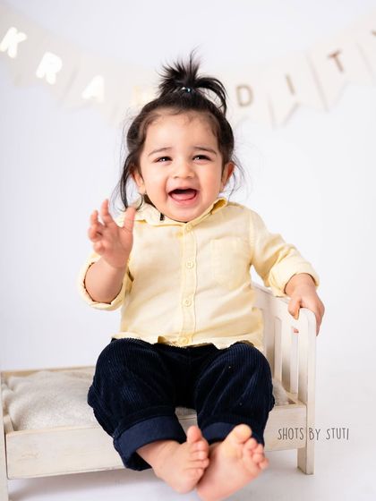 This little boy's happy wave and infectious smile lit up the entire studio. Milestone sessions for one year olds are full of energy and joy, and I love capturing every bit of it.
