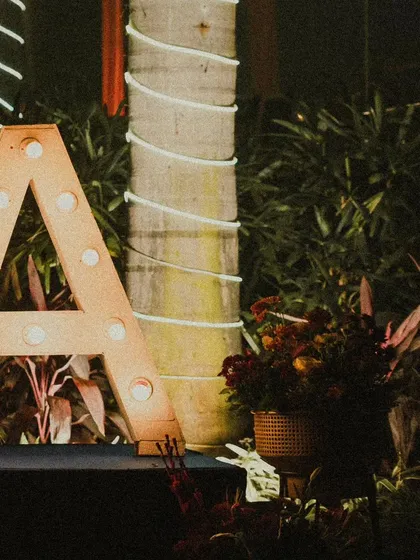 A close-up of the marquee letter 'A', showcasing the warm, inviting glow it adds to the evening's ambiance. These details make the decor feel truly custom.