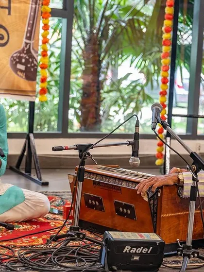 A focused shot of me singing, accompanied by my teacher on the harmonium. This student teacher relationship is central to the tradition of Indian classical music.