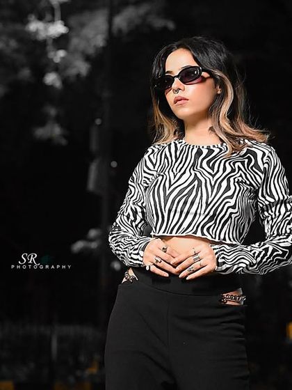 A creative edit of a night street style shoot, using a black and white background to emphasize the model.