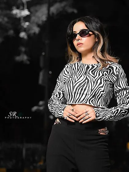 A creative edit of a night street style shoot, using a black and white background to emphasize the model.